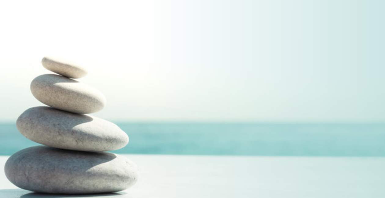 Young dad smiling and high-fiving young son while mom watches and smiles